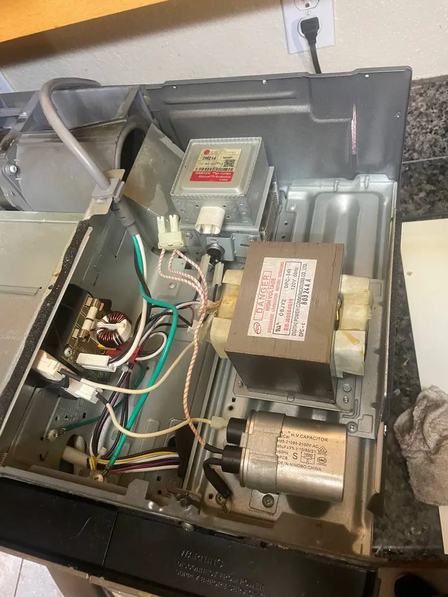 Microwave magnetron tube being replaced — EasyBear technician repair