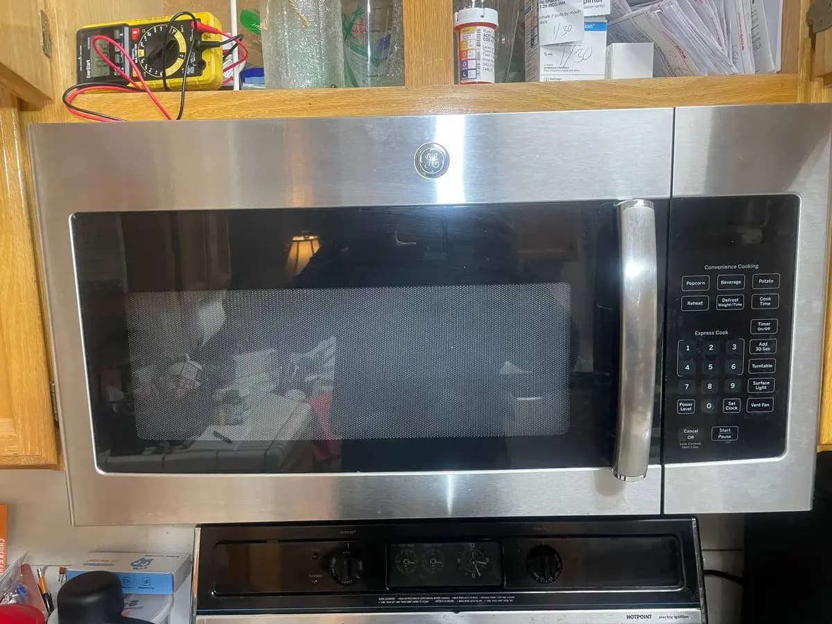 GE over-the-range microwave installed above stove — EasyBear repair