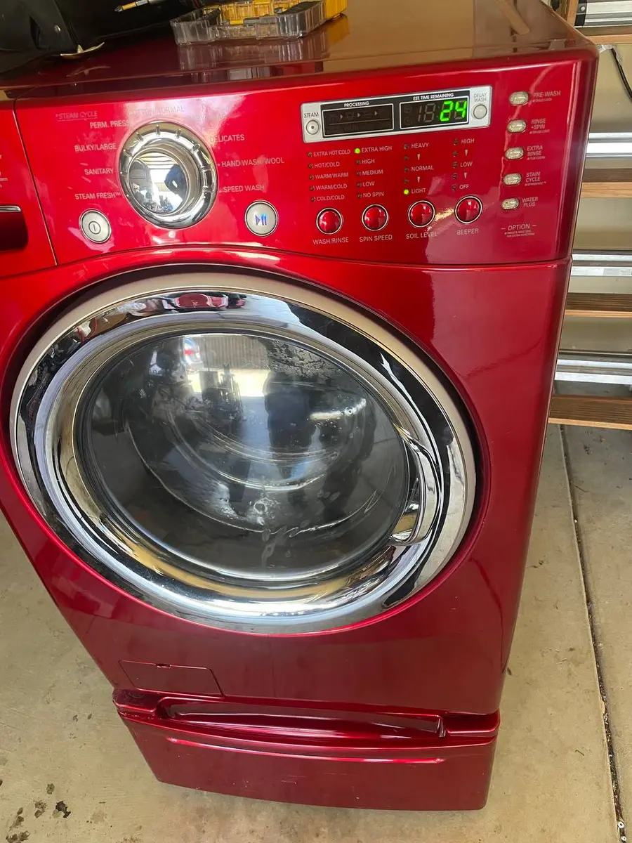 LG front-load washer with red finish in customer garage — EasyBear service call